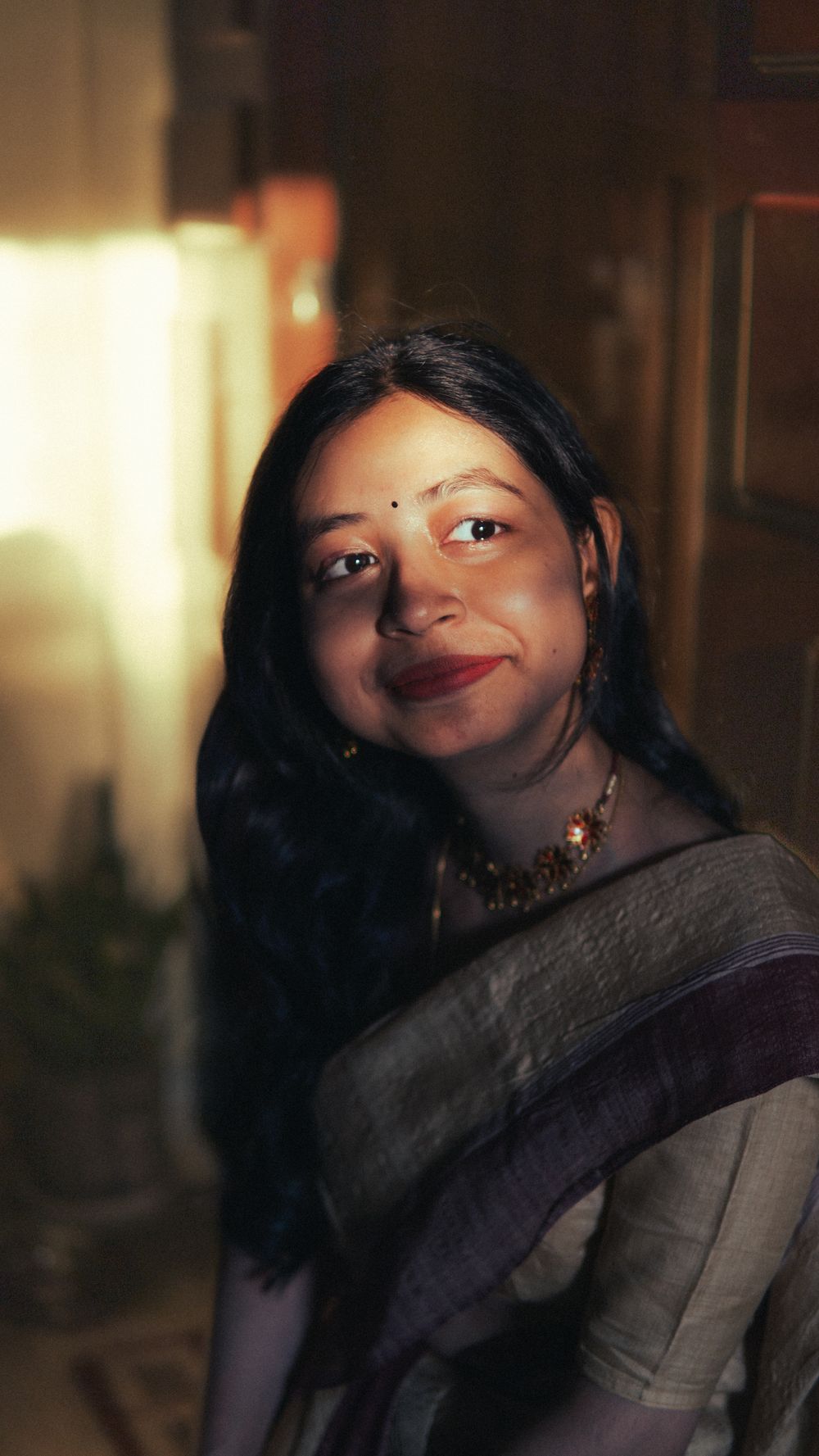 Meera Bhandari, photographed in warm evening light, looking directly at the camera